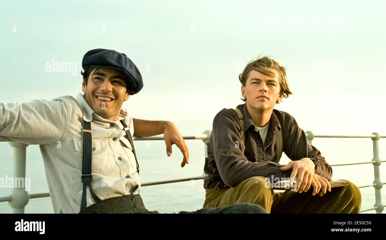 USA. Leonardo DiCaprio and Danny Nucci in a scene from the ©Paramount  Pictures film : Titanic (1997) . Plot: A seventeen-year-old aristocrat  falls in love with a kind but poor artist aboard