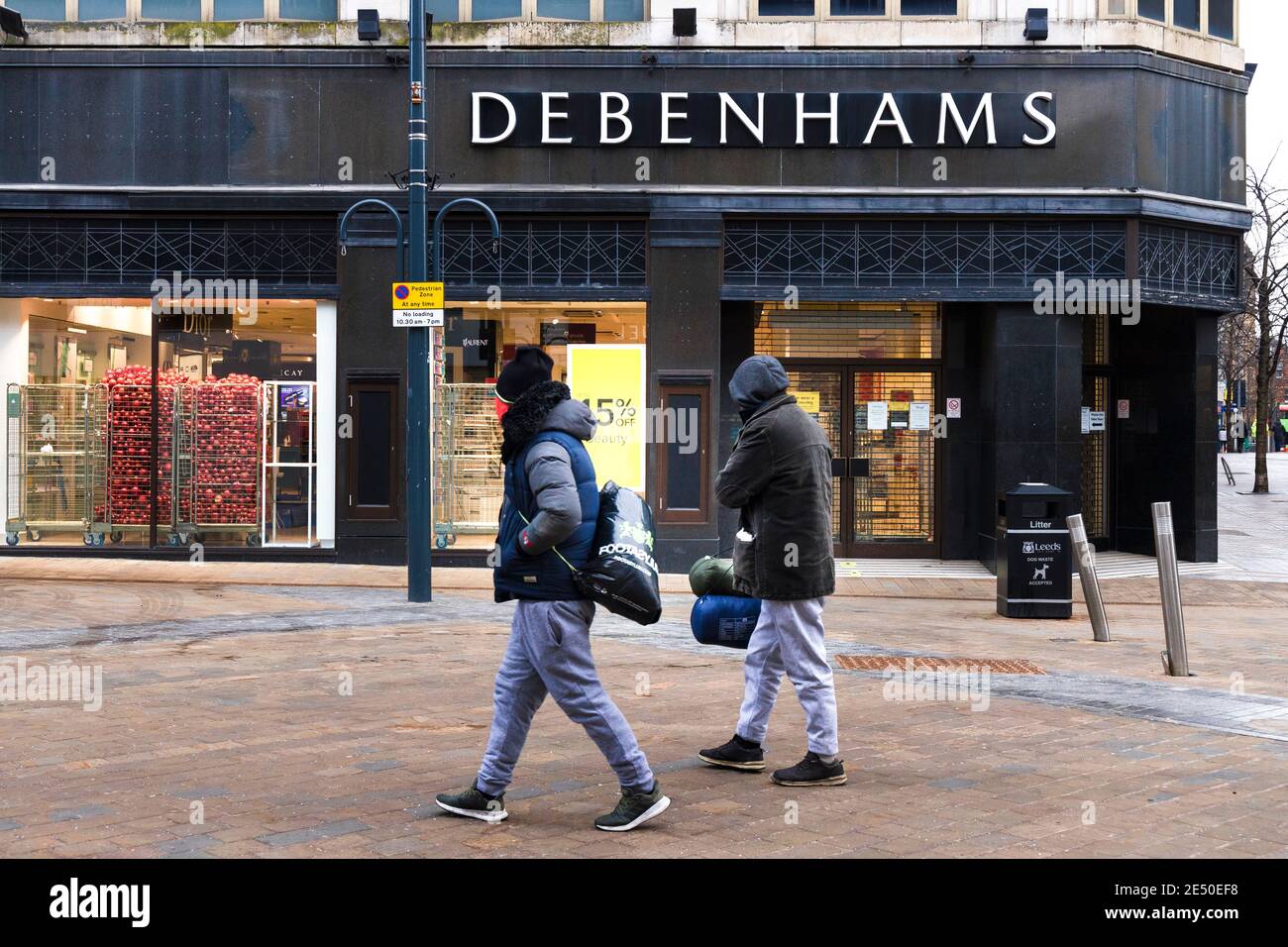 Closed Debenhams store in Briggate, Leeds city centre, Yorkshire, England, with people walking past Stock Photo