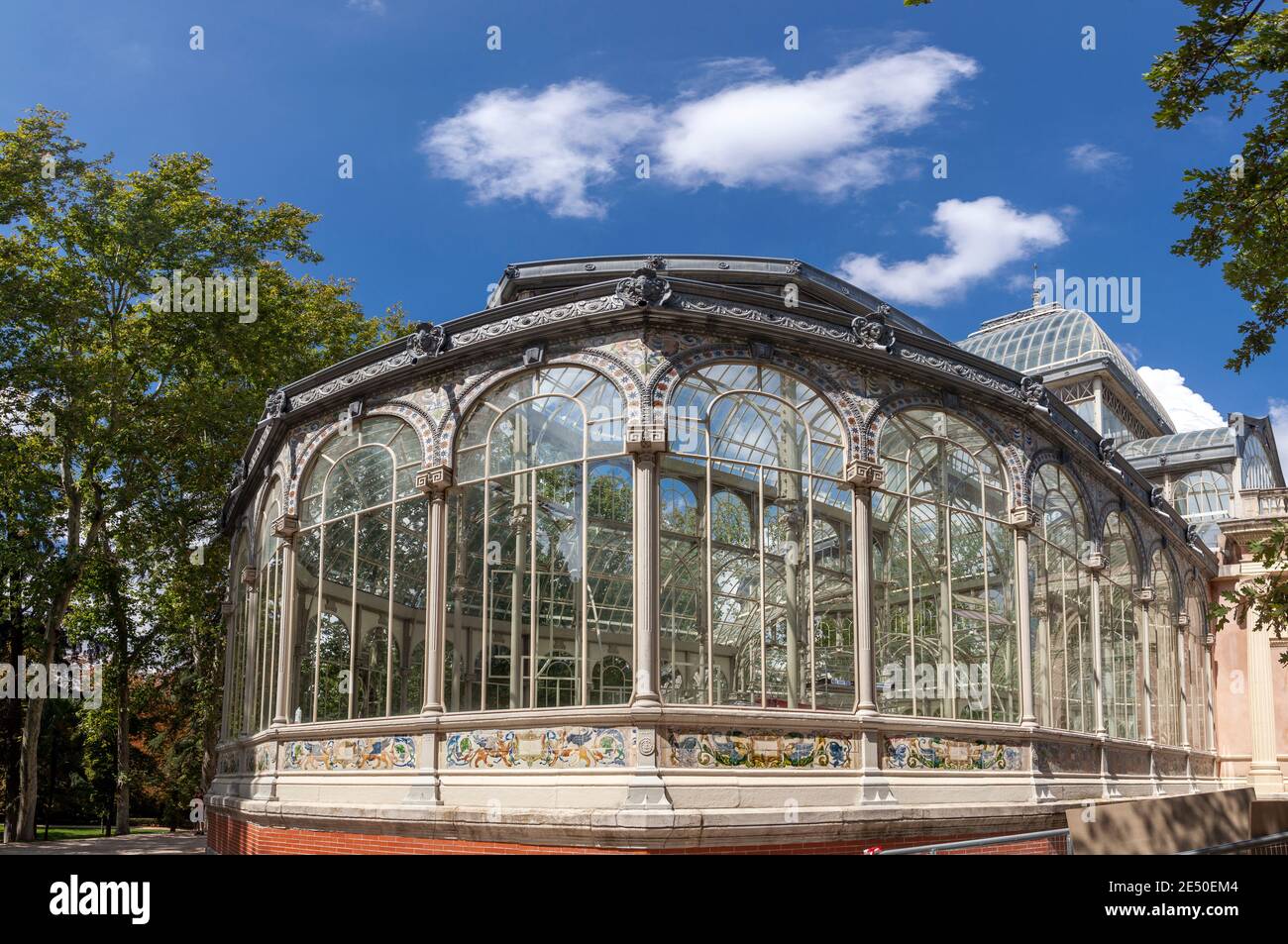 Palacio de Cristal, or The Crystal Palace, a beautiful old mansion made primarily of crystal and used for events, in the Retiro Park, in Madrid, Spain Stock Photo