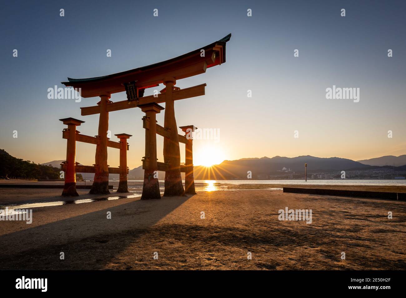 Wide angle view of the Itsukushima torii at sunset with shallow water Stock Photo