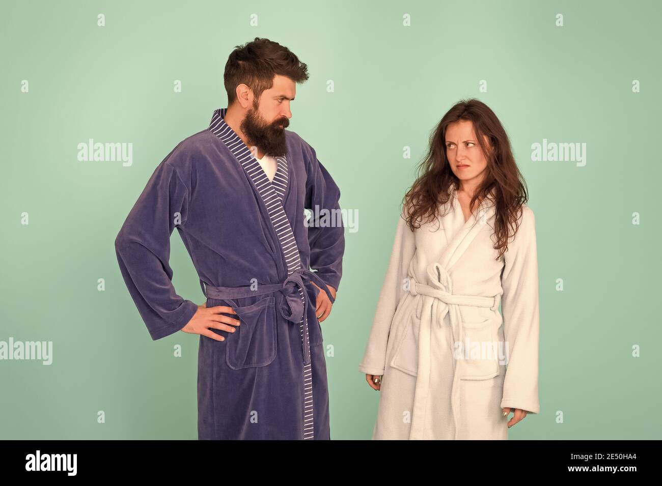 Being sad is a choice. Couple in love look sad. Sad woman and man wear bathrobes blue background. Family conflict. Depression and stress. Bedtime or morning routine. Health care. Unhappy and sad. Stock Photo