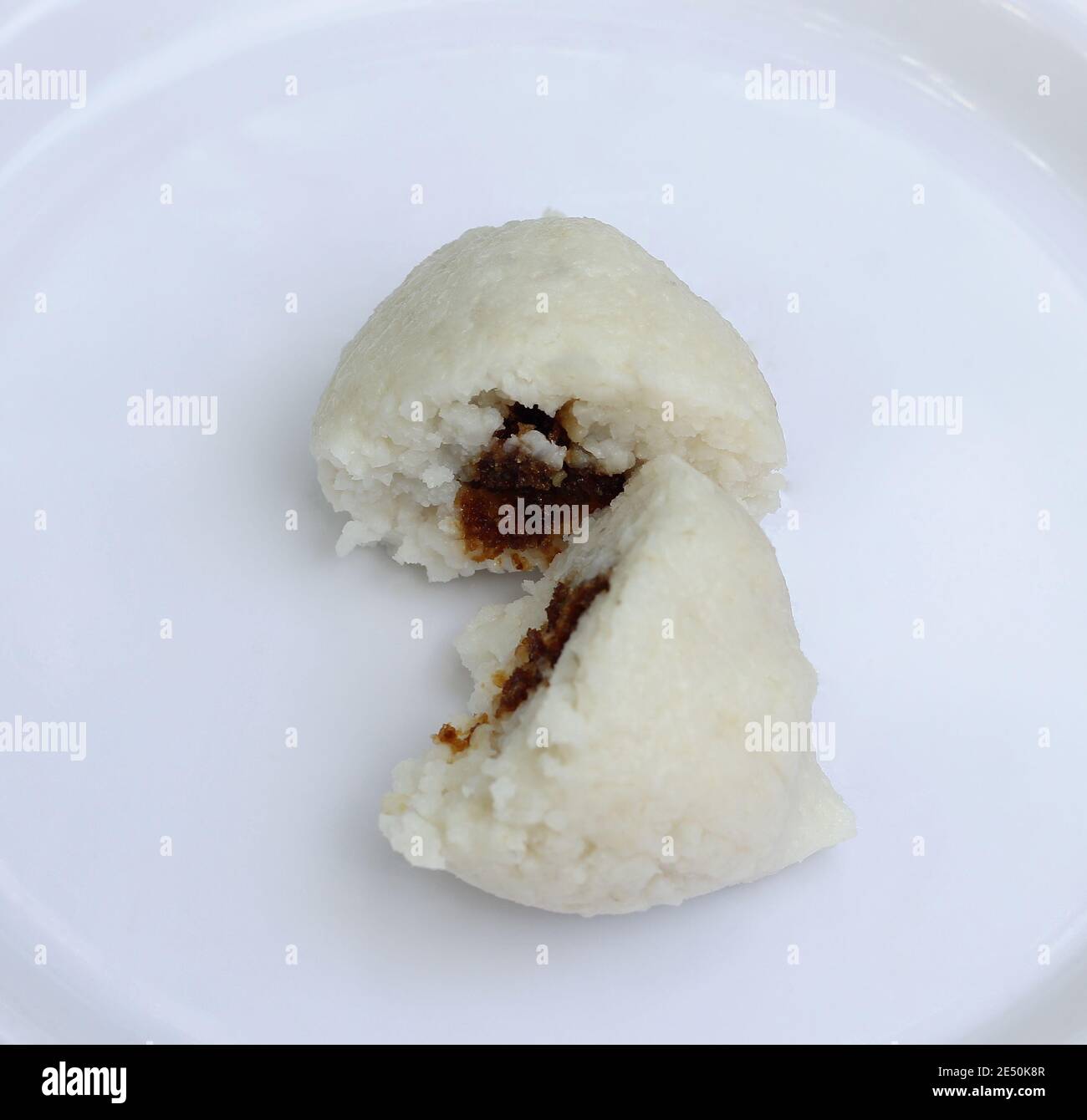 Selective focuse on sweet filling made of coconut and jaggery on a sliced cylindrical shape Imbul Kiribath Stock Photo