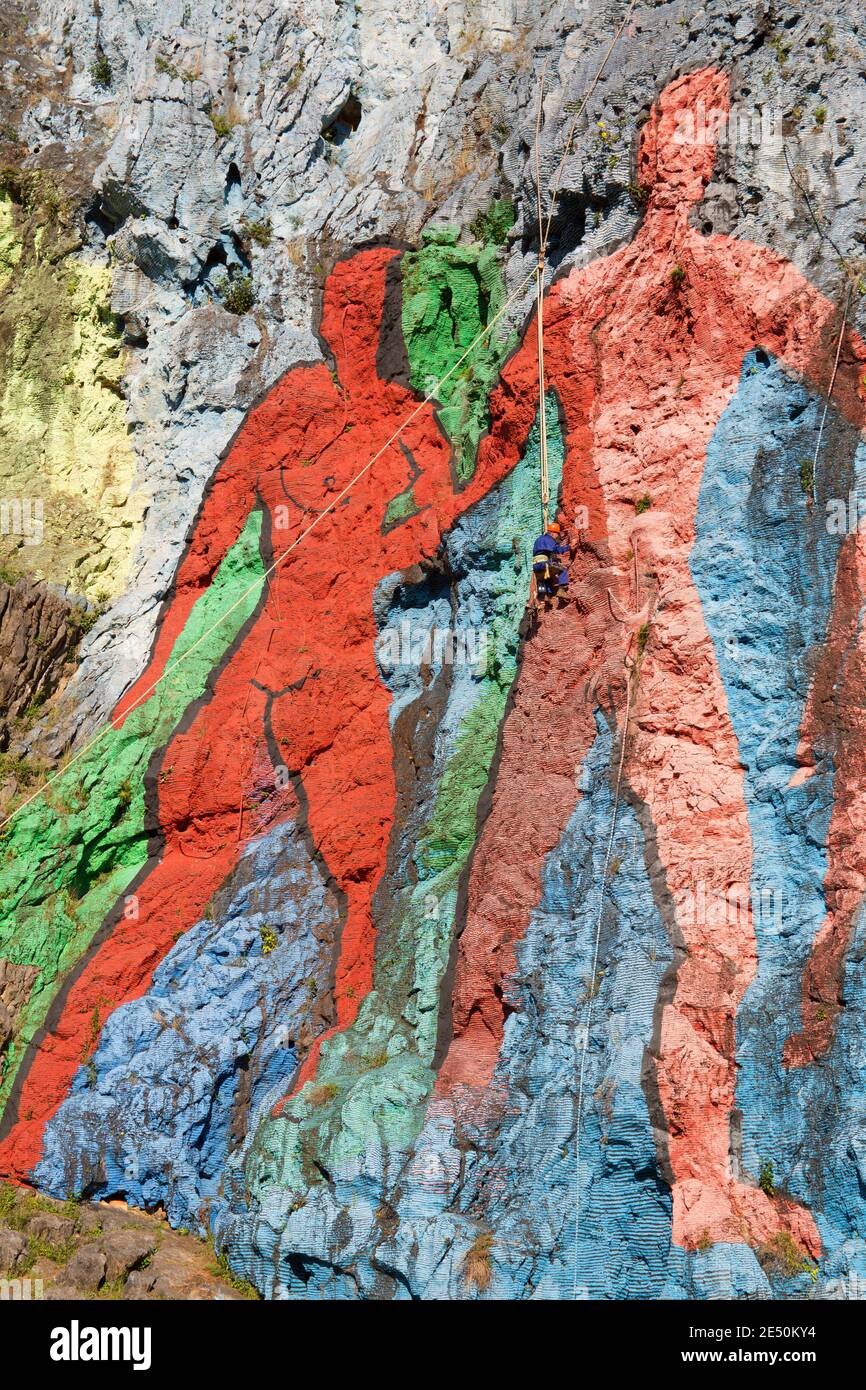 Prehistoric Rope Workman hanging from ropes, restoring paintwork of Mural de la ...