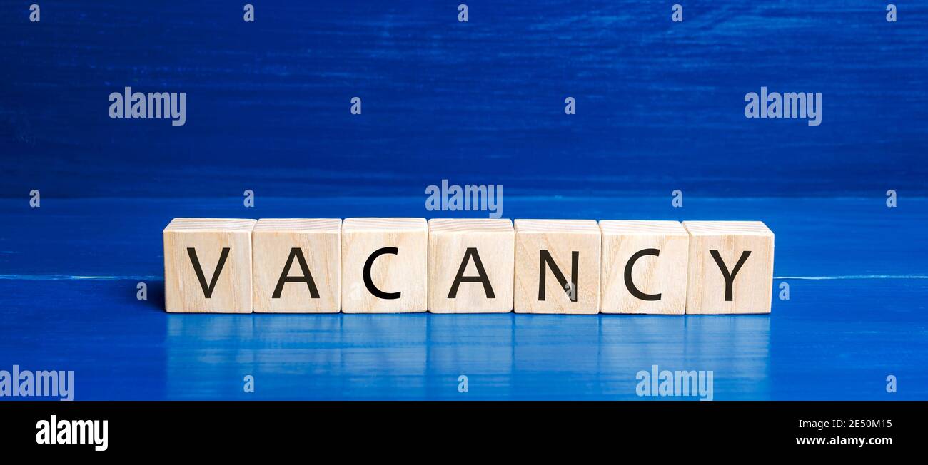 Wooden blocks with the word Vacancy. Hire a worker. Position offered by a business. Workplace. Human Resource Management. Recruiting Headhunting. Hiri Stock Photo