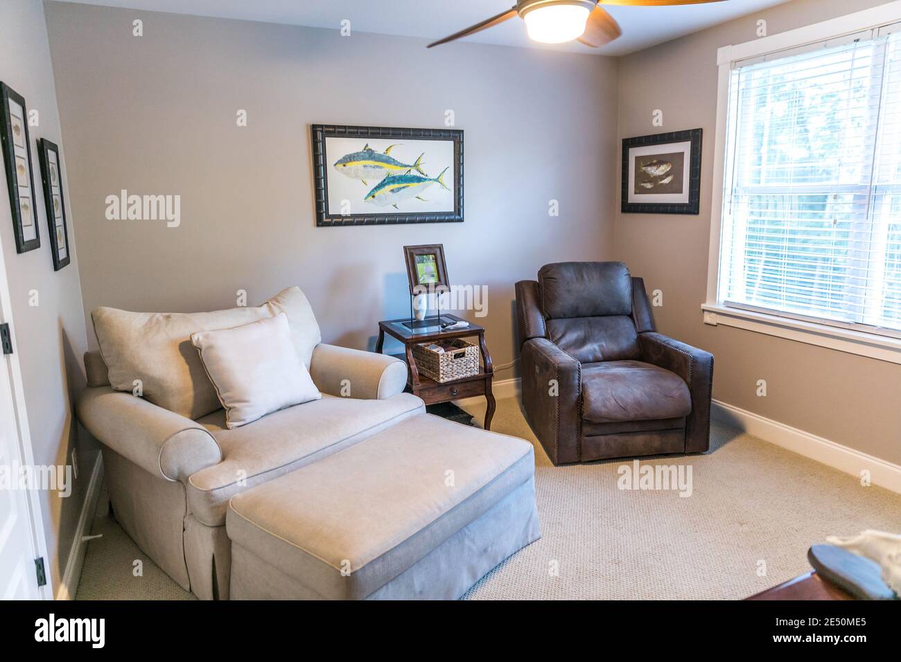 Spare extra bedroom mad einto a sitting room wih oversized armchairs Stock Photo