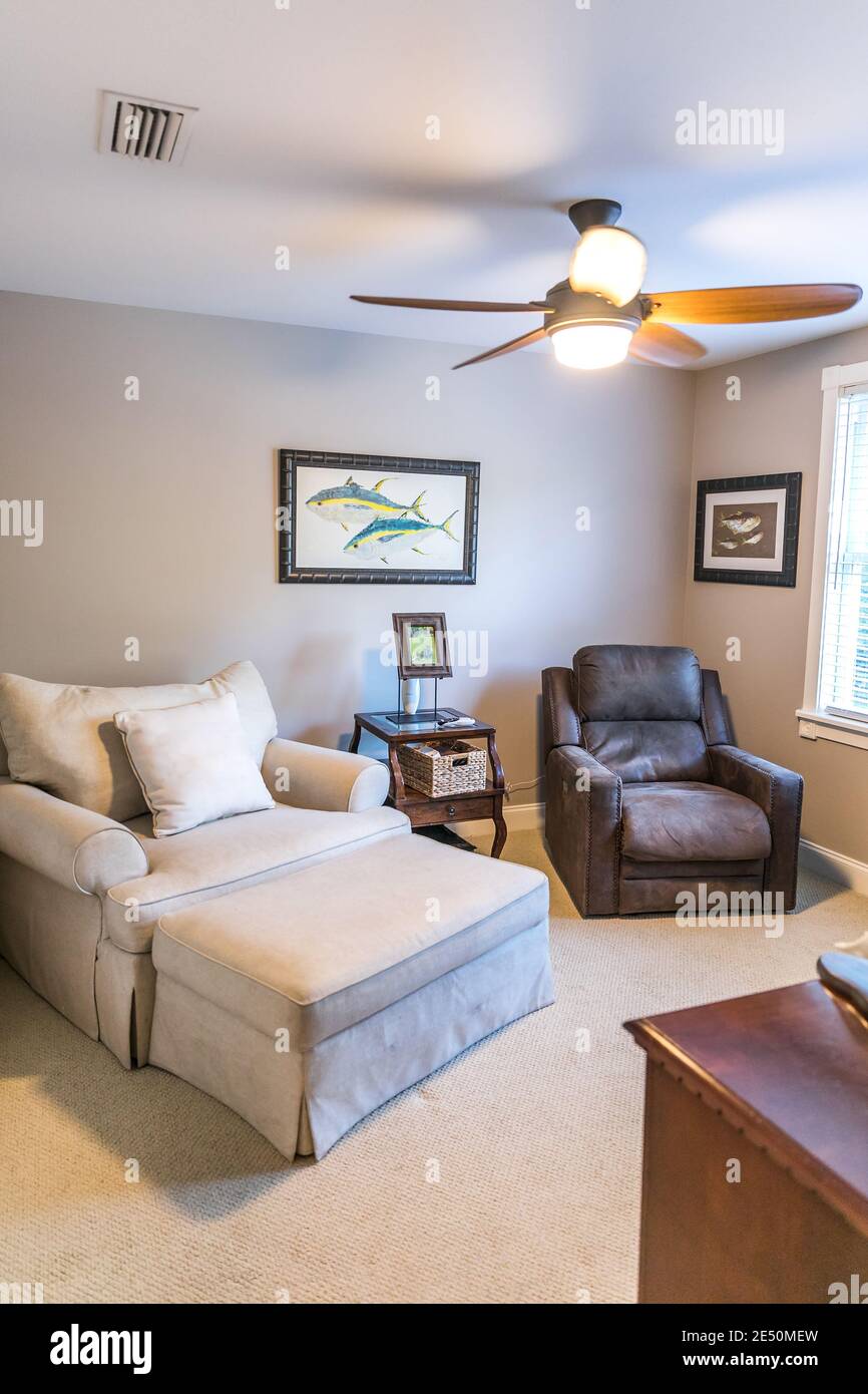 Spare extra bedroom mad einto a sitting room wih oversized armchairs Stock Photo