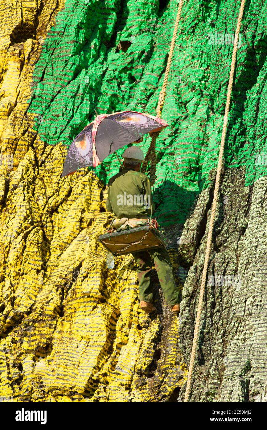 Prehistoric Rope Workman hanging from ropes, restoring paintwork of Mural de la ...