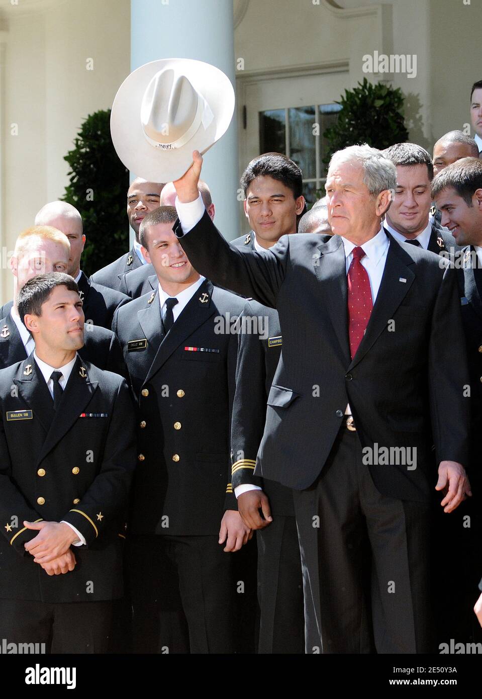 US President George W. Bush carries on a cowboy hat given to him by ...