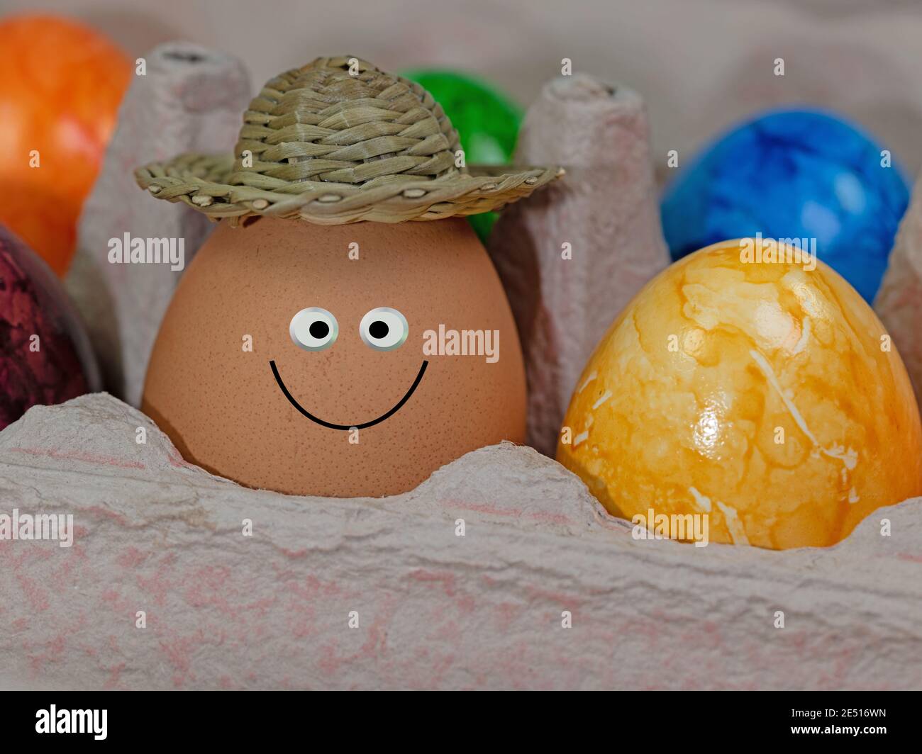 Egg with a funny face in the packaging Stock Photo