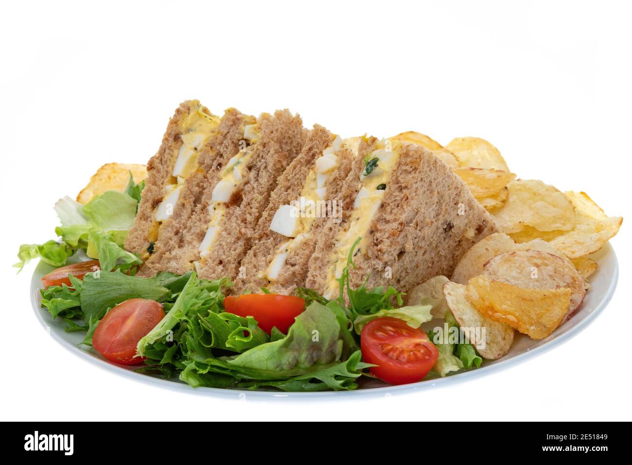 Egg and cress sandwich with potato crisps and salad white background