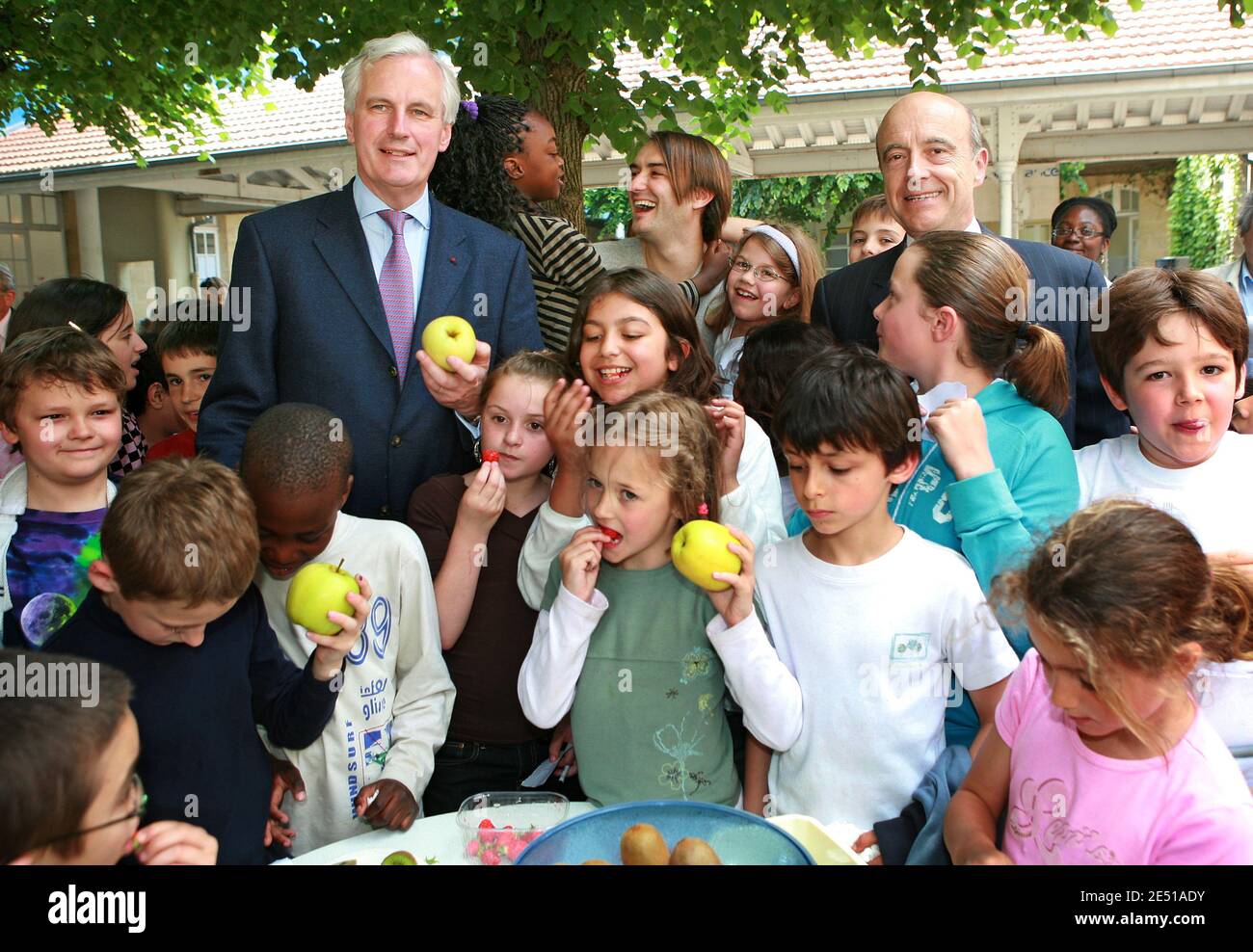 (L-R) French Minister for Agriculture and Fisheries Michel Barnier, TV chef Cyril Lignac and Bordeaux Mayor Alain Juppe are surrounded by school children as they help launching the campaign 'A Fruit at the Recess' to spur on children to eat more fruits, in a school in Bordeaux, southwestern France on May 6, 2008. Photo by Patrick Bernard/ABACAPRESS.COM Stock Photo