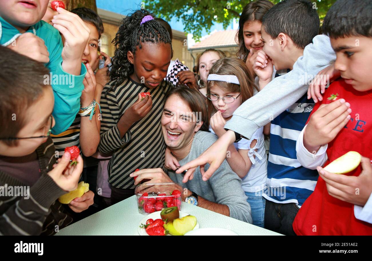 French TV chef Cyril Lignac is surrounded by school children as he helps launching the campaign 'A Fruit at the Recess' to spur on children to eat more fruits, in a school in Bordeaux, southwestern France on May 6, 2008. Photo by Patrick Bernard/ABACAPRESS.COM Stock Photo