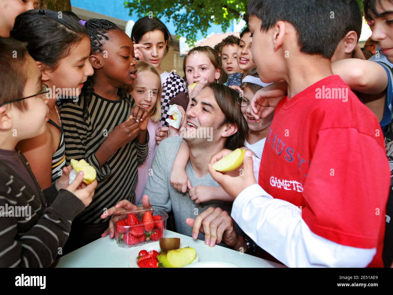 French TV chef Cyril Lignac is surrounded by school children as he helps launching the campaign 'A Fruit at the Recess' to spur on children to eat more fruits, in a school in Bordeaux, southwestern France on May 6, 2008. Photo by Patrick Bernard/ABACAPRESS.COM Stock Photo