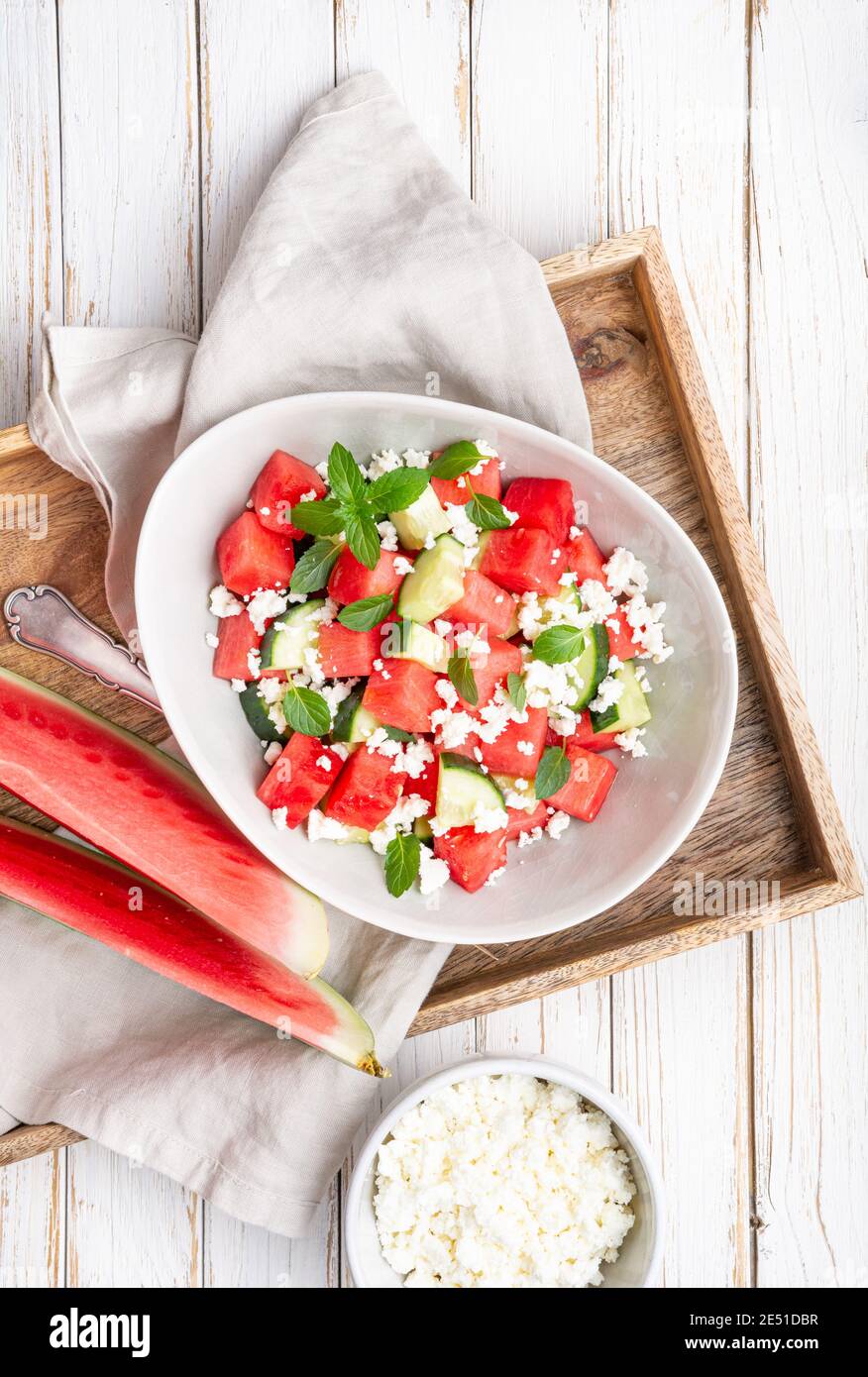 Summer Mediterranean watermelon salad with Feta cheese, cucumber and mint leaves Stock Photo