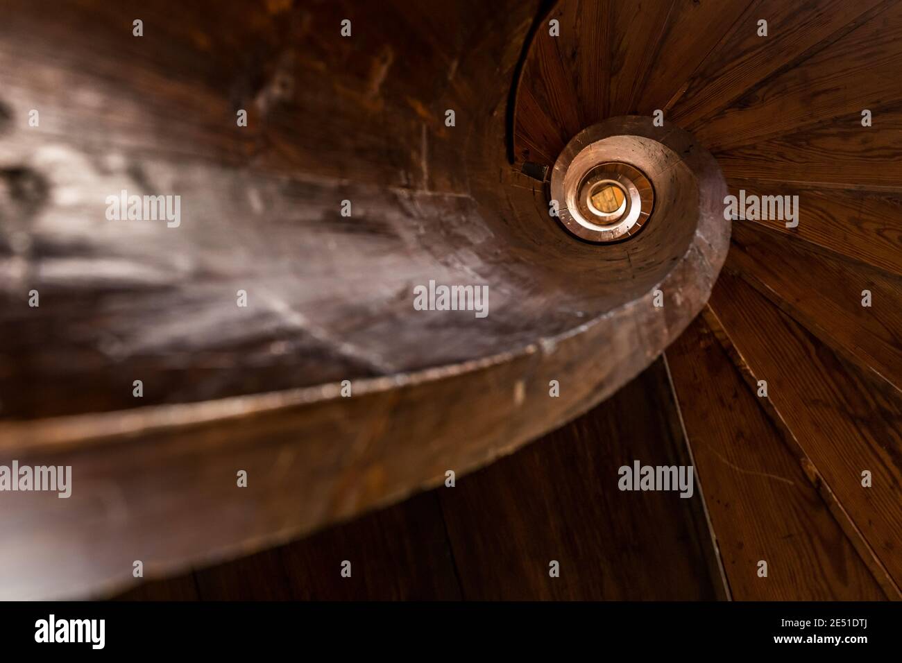 Close up of the stairwell of an ancient wooden spiral staircase Stock Photo
