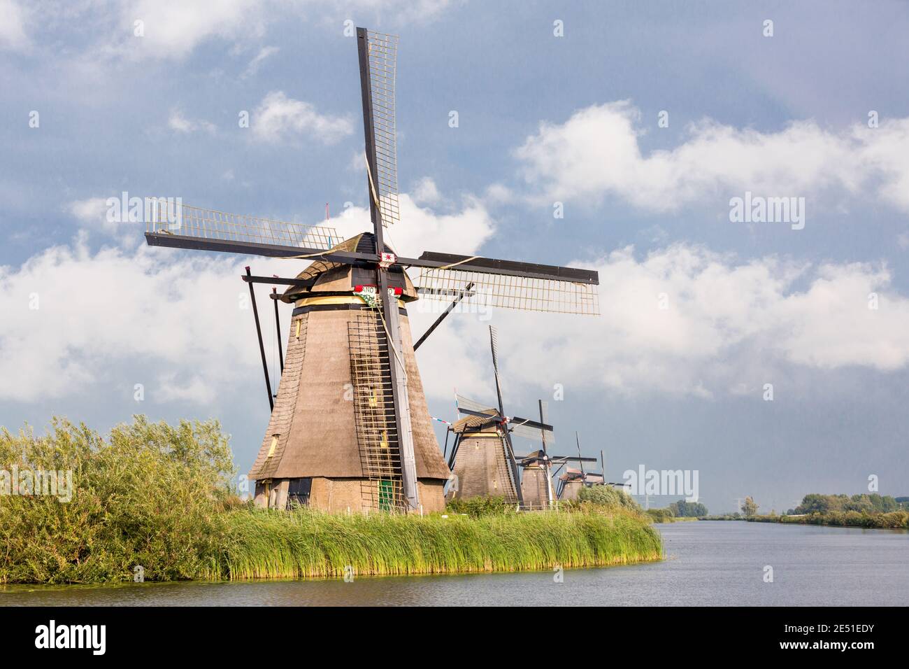 Wide Angle View Of A Long Row Of Ancient Water front Windmills In Wide Angle View Of A Long Row Of Ancient Water front Windmills In