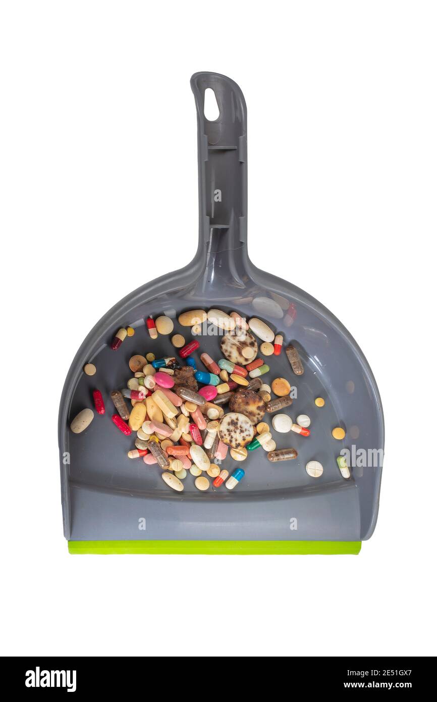 Macro Photo Of Worn Dustpan Full of Pills. A Pile of Decayed Pills on Dustpan as Waste. Pharmaceutical Products After Years. Stock Photo
