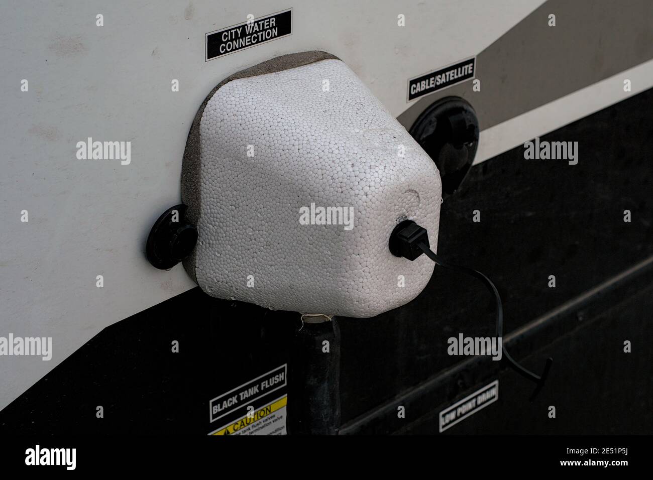 Foam freeze protector on water hose entering side of RV camper van