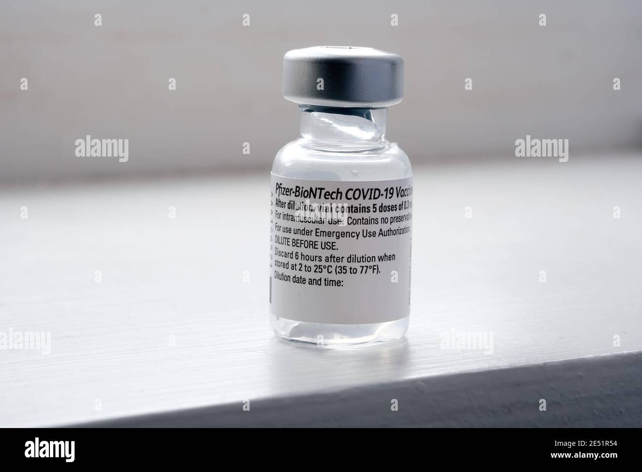 Genuine Pfizer BioNTech COVID-19 Vaccine vial. Real vaccine photo. Selective focus. Stafford, United Kingdom - January 23 2021. Stock Photo