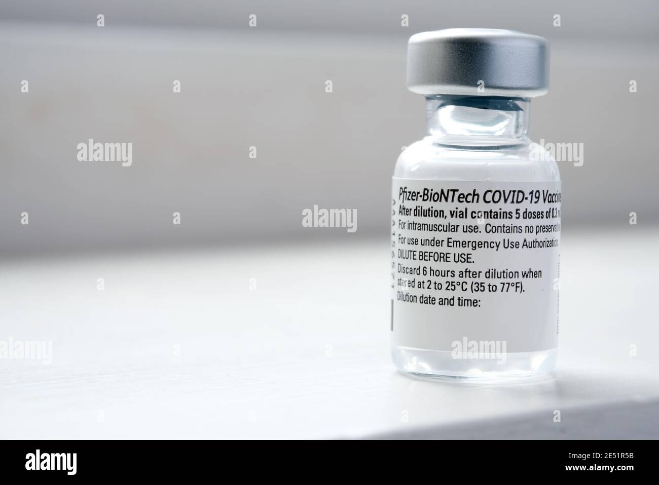 Genuine Pfizer BioNTech COVID-19 Vaccine vial. Real vaccine photo. Selective focus. Stafford, United Kingdom - January 23 2021. Stock Photo
