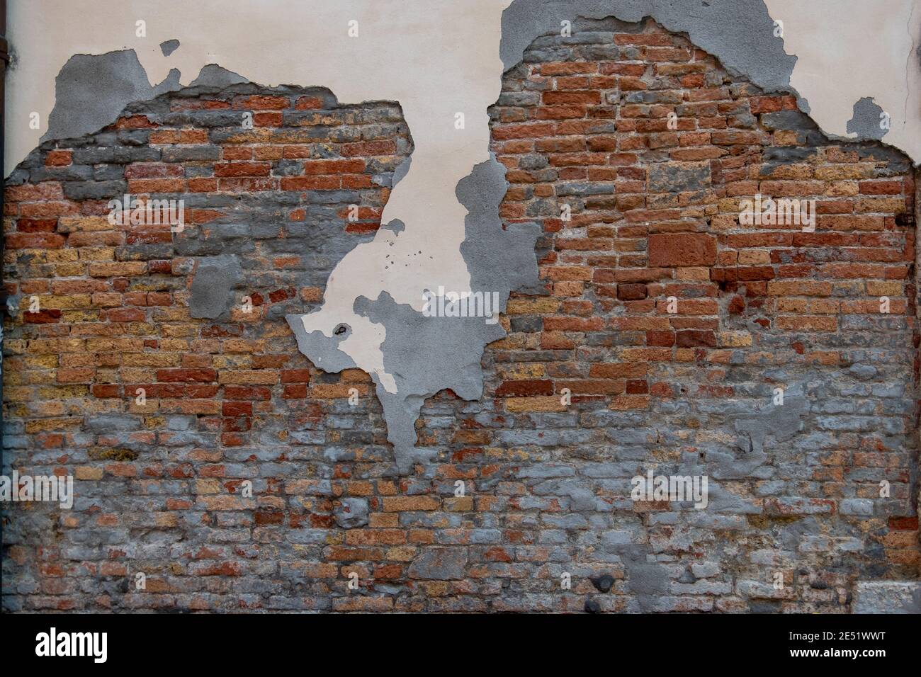 exceptionally beautiful old brick wall in Venice with flaked plaster in