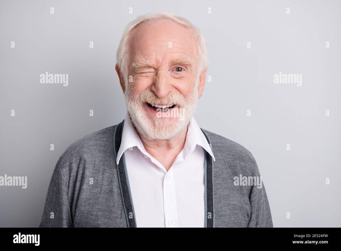 Portrait of old white hair optimistic man blink wear dark sweater isolated  on grey background Stock Photo - Alamy