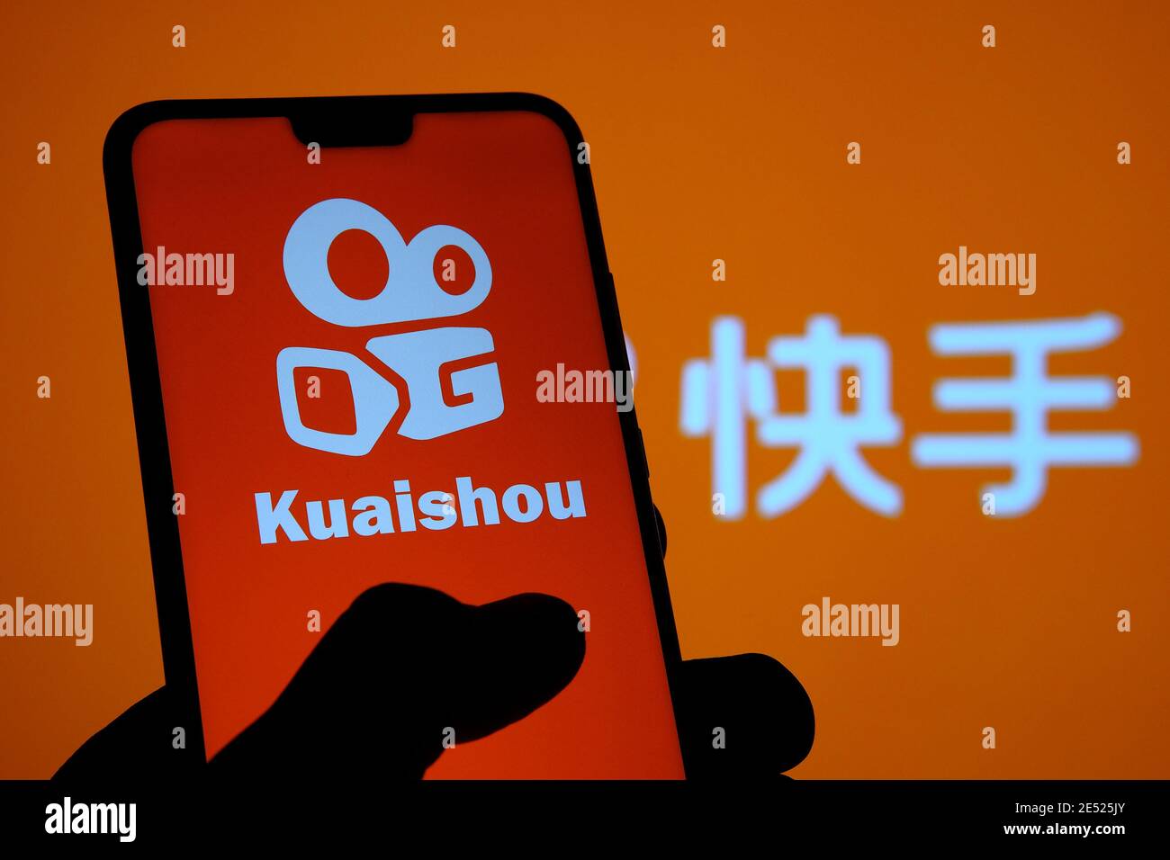 Kuaishou app logo seen on the smartphone screen and blurred background with  chinese letters translated as 