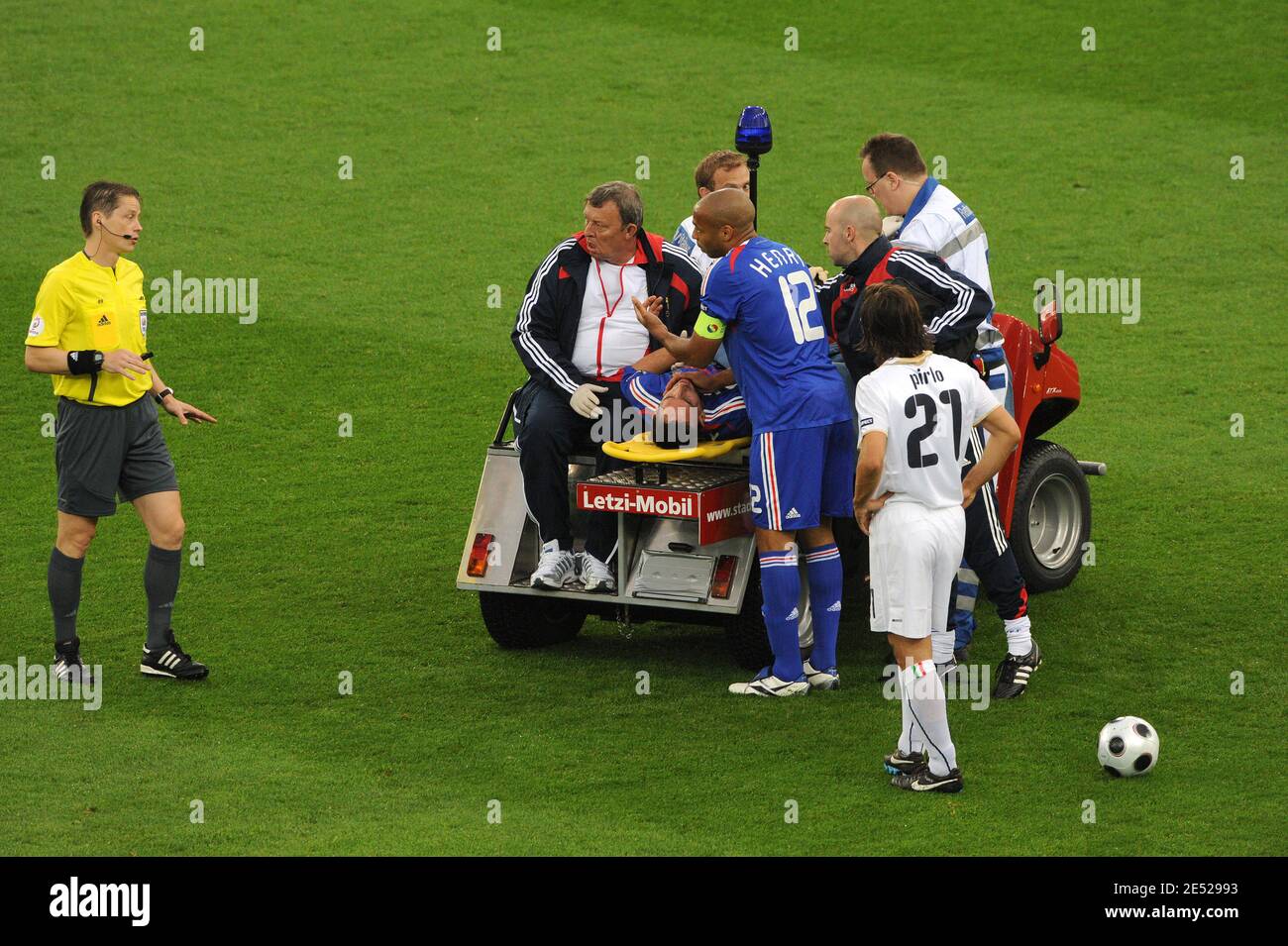 France's Franck Ribery is injured and his teammates Thierry Henry consoles  him, he receives treatment by doctor Jean-Pierre Paclet during the Euro  2008, UEFA European Championship, Group C, France vs Italy at