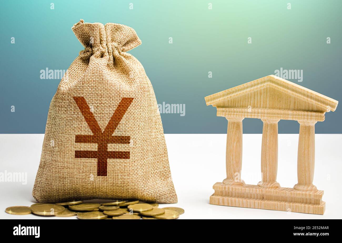 Yuan or Yen money bag and bank / government building. Budgeting, national financial system. Monetary policy. Resource allocation. Support businesses i Stock Photo