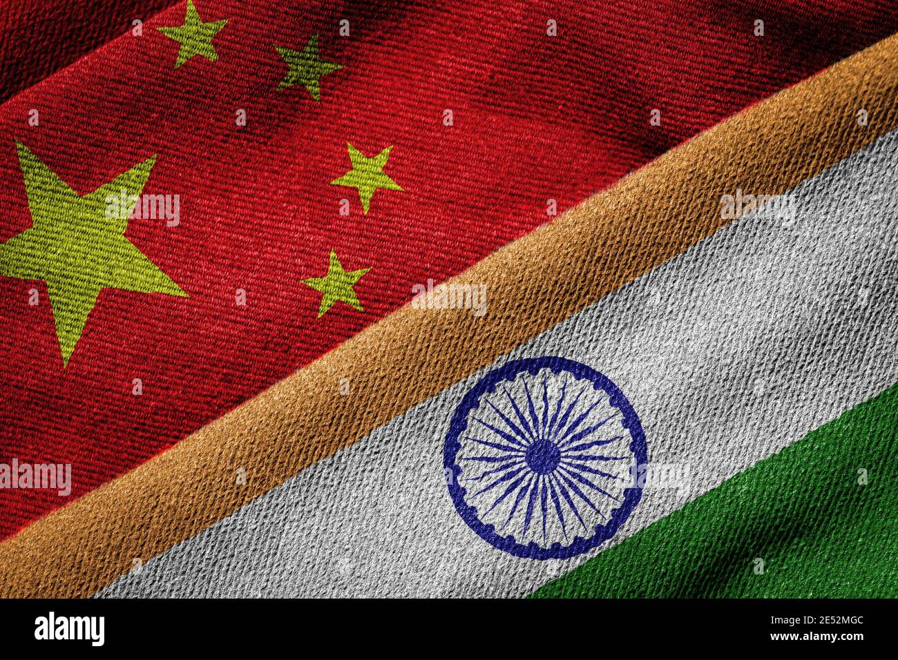 Overlapping grunge flags of India and China, concept of relations and ongoing political tension between the two countries. Stock Photo