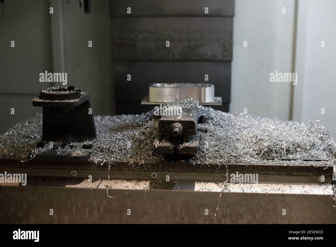 Metal shavings after workpiece processing on CNC milling machine. Selective focus. Stock Photo