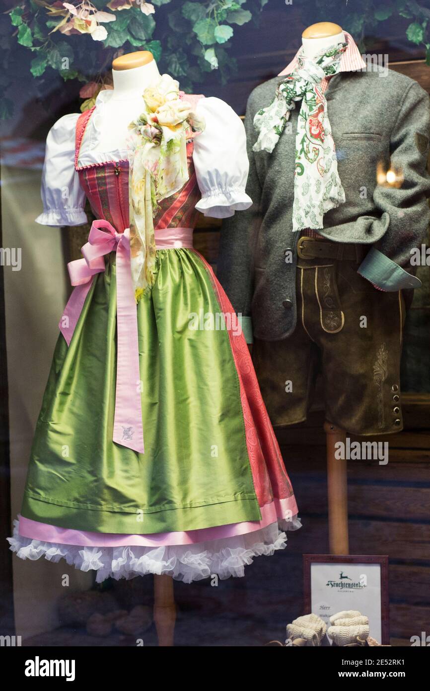 A traditional dirndl and lederhosen on display in a shop window in Salzburg, Austria. Stock Photo
