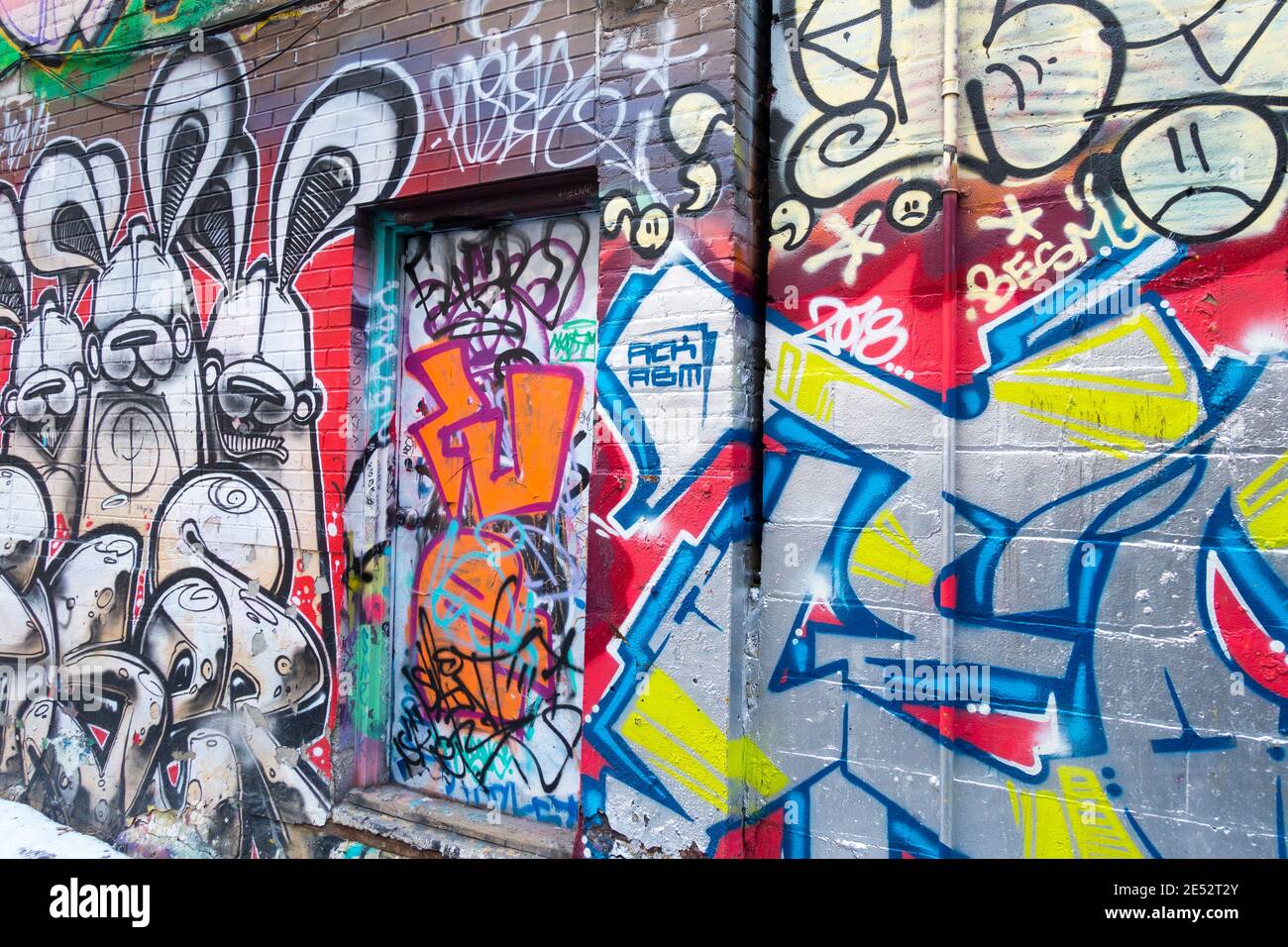 A large number of colourful wall paintings that have become a minor tourist attraction in an area known as Graffiti Alley in Toronto Ontario Canada Stock Photo