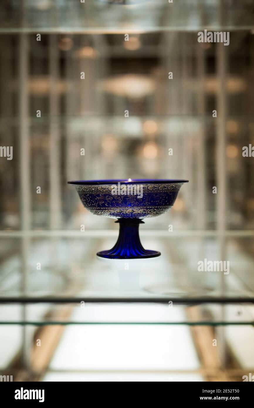 An ornate cobalt blue glass pedestal bowl on display at the Museum of Applied Arts (MAK) in Vienna, Austria. Stock Photo