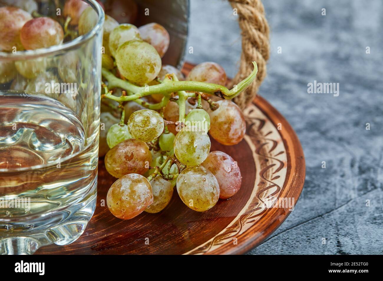 White wine in a glass with a bunch of green grapes around Stock Photo ...