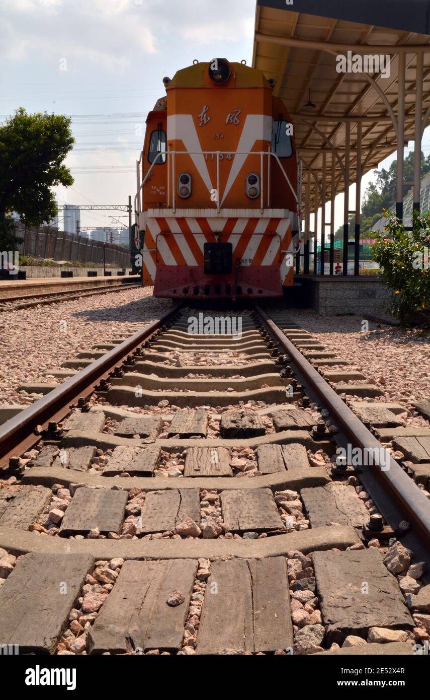 Old locomotive train and carriages in Shenzhen, China. Platform and station sign from the old Shenzhen to Beijing line. Stock Photo