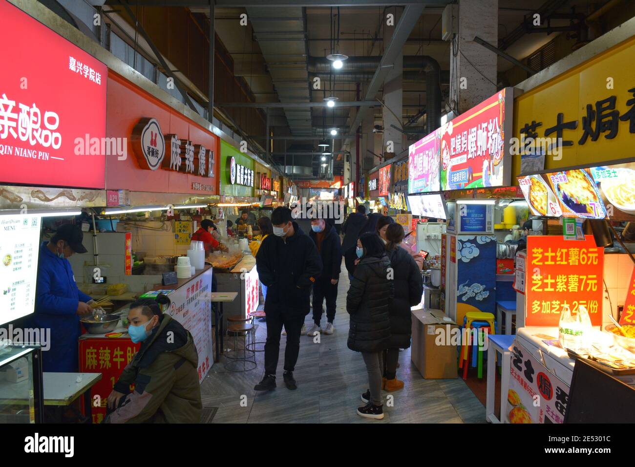 Street food market in Jiaxing, Zhejiang, China. Indoor stalls selling various fast food snacks.Jan 2020 Stock Photo