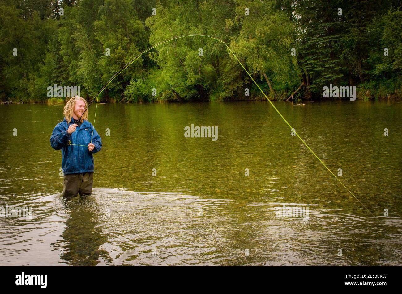 This young man is enjoying a quiet afternoon of Fly Fishing on the Kijik River in Southwest Alaska. Stock Photo