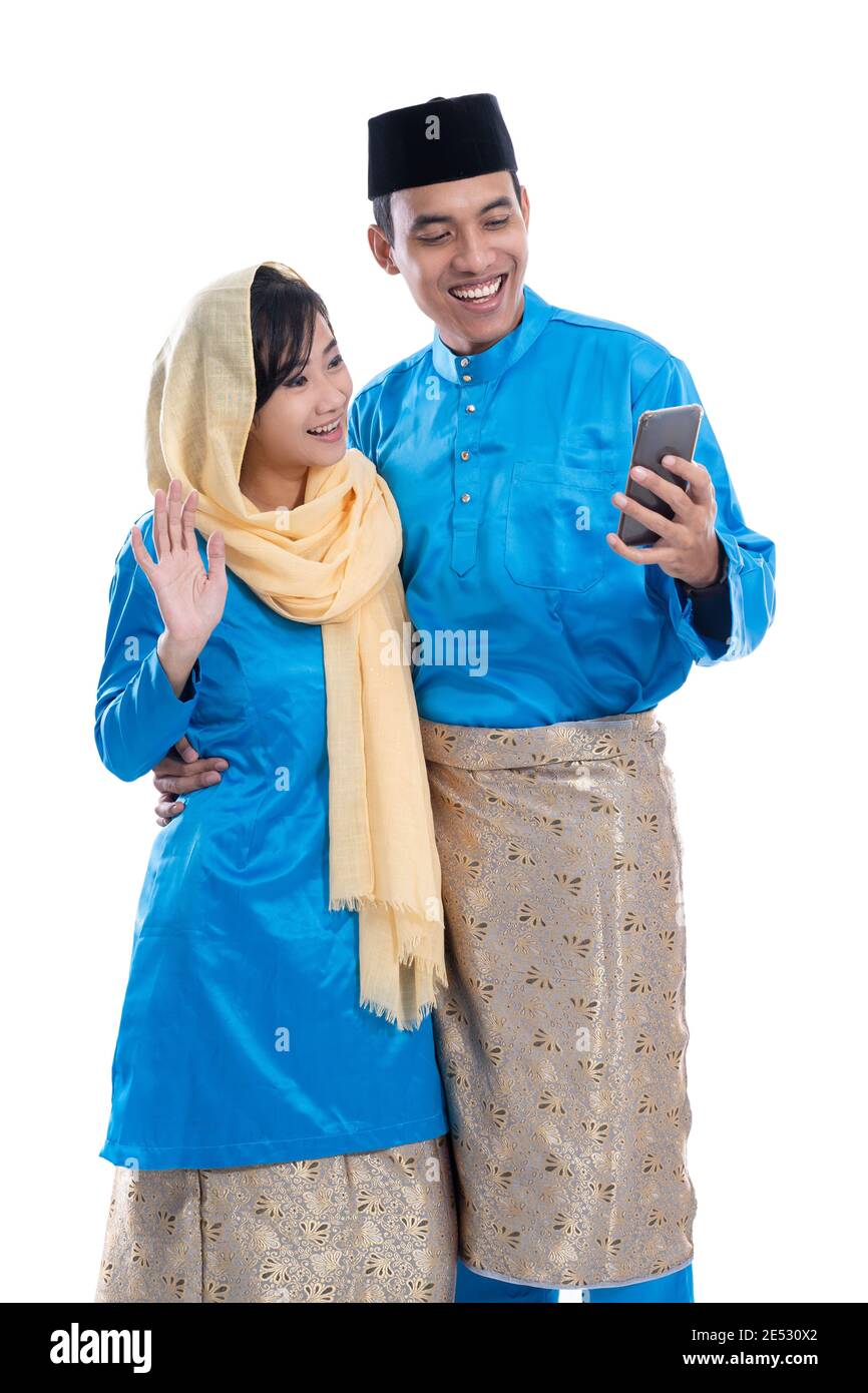 muslim couple using mobile phone isolated over white background Stock Photo