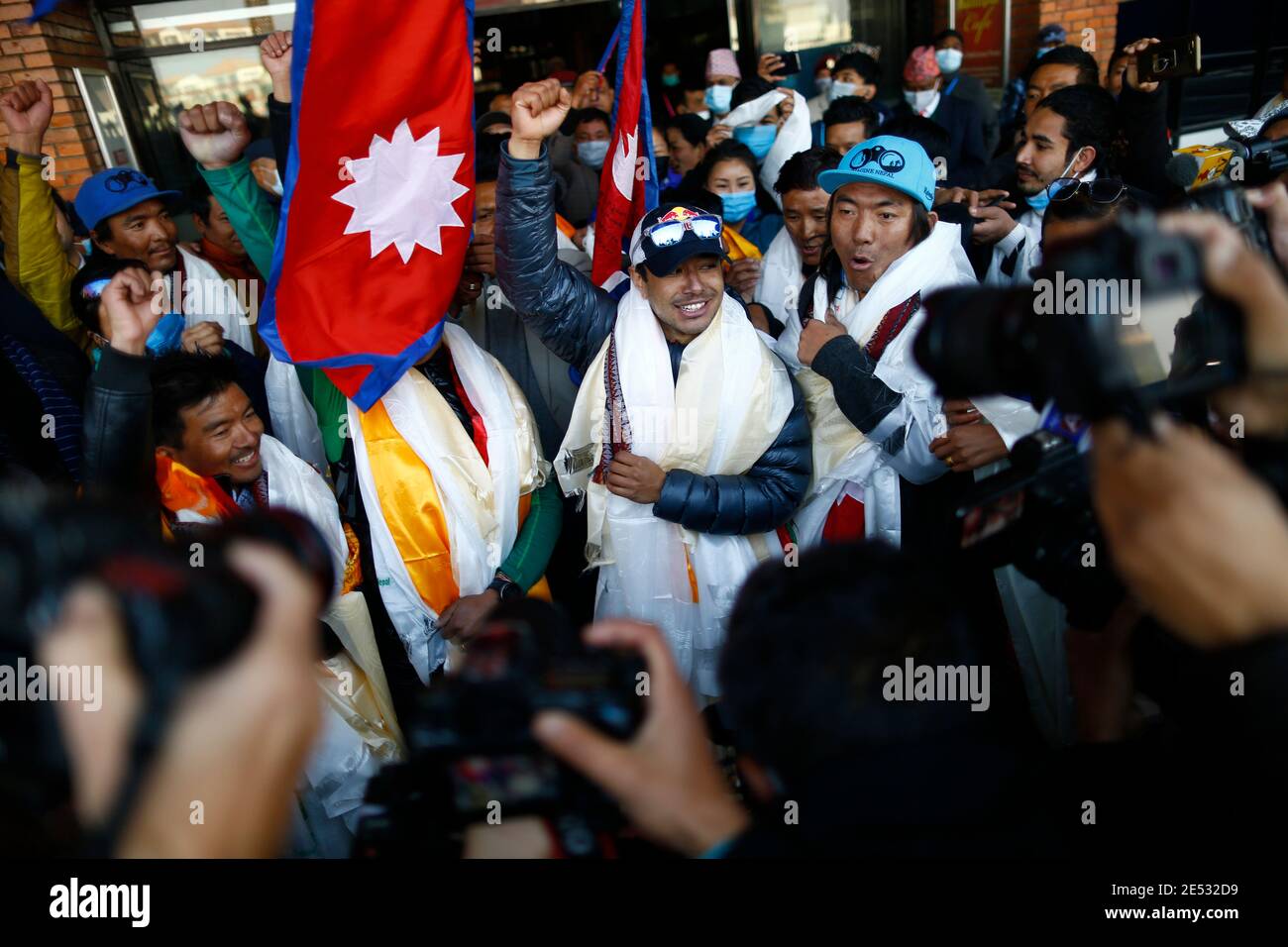 Kathmandu, Nepal. 25th Jan, 2021. Nepalese climber Nirmal Purja, who along with his team recently made history by scaling the K2 summit in the winter season, gestures upon his arrival to Tribhuvan International Airport in Kathmandu, Nepal on Tuesday, January 26, 2021. Credit: Skanda Gautam/ZUMA Wire/Alamy Live News Stock Photo