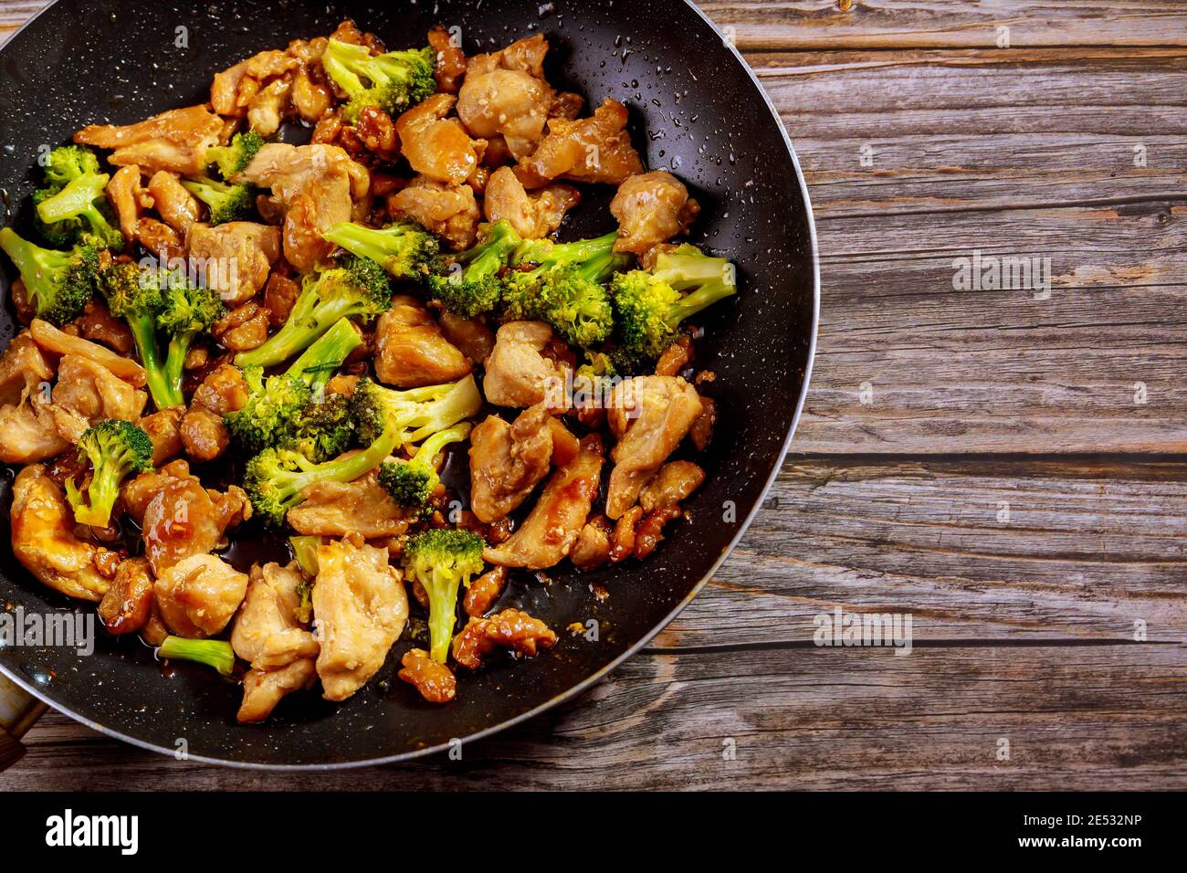 Stir fry with chicken and broccoli on wok. Chinese food. Copy space. Stock Photo