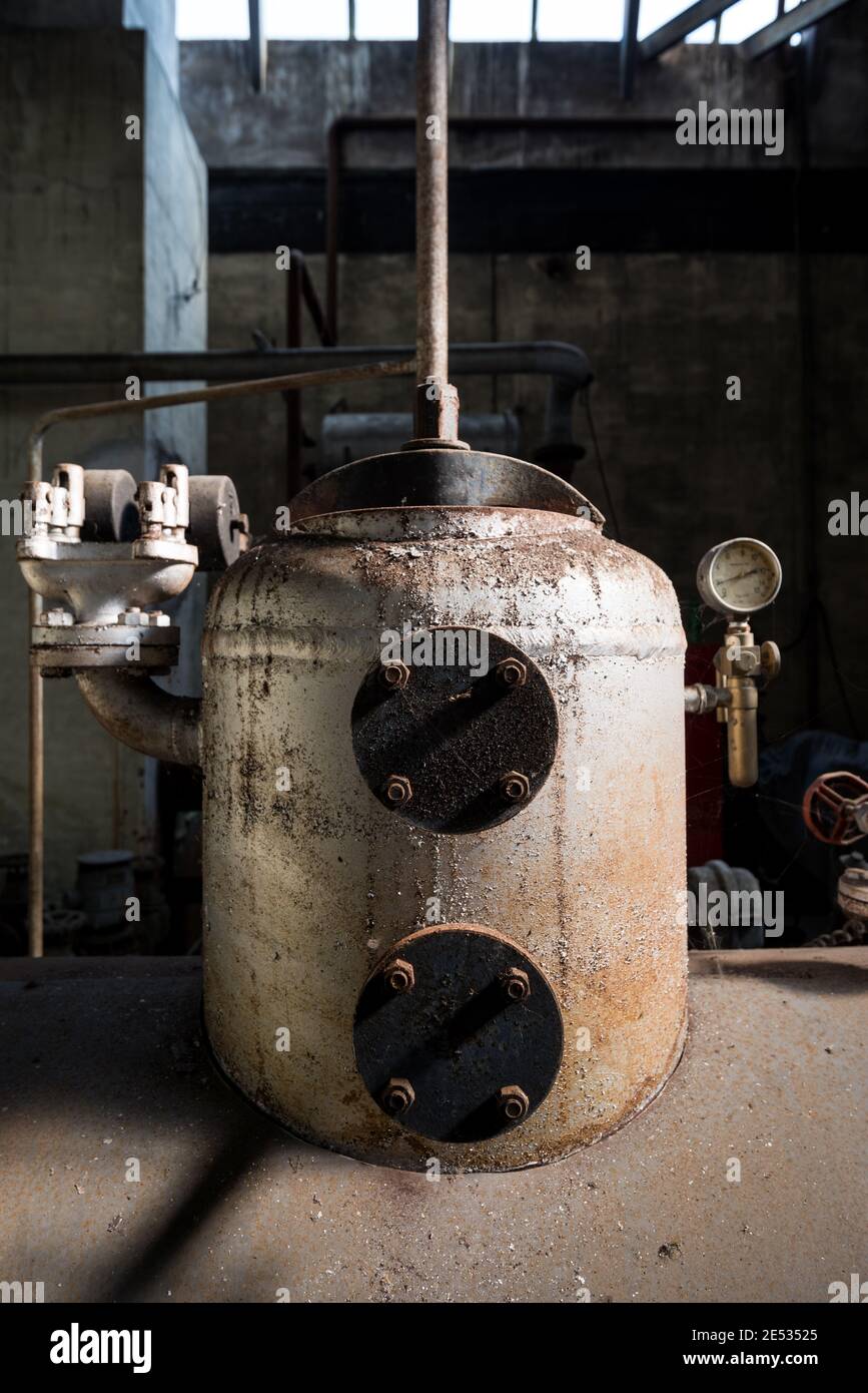 Symmetrical view of the boiler room in an old and abandoned Italian textile factory Stock Photo