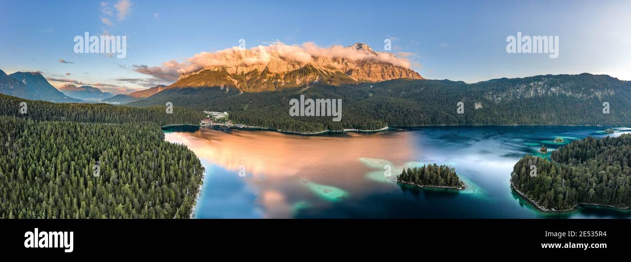 Panoramic aerial view of Alpenglow Zugspitze with fog by Eibsee lake in ...