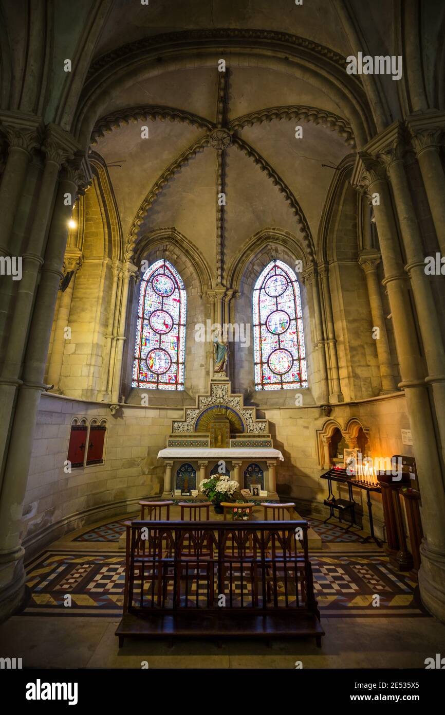 Wide angle shot of a french gothic chapel, with pointed arches and stained glass windows Stock Photo