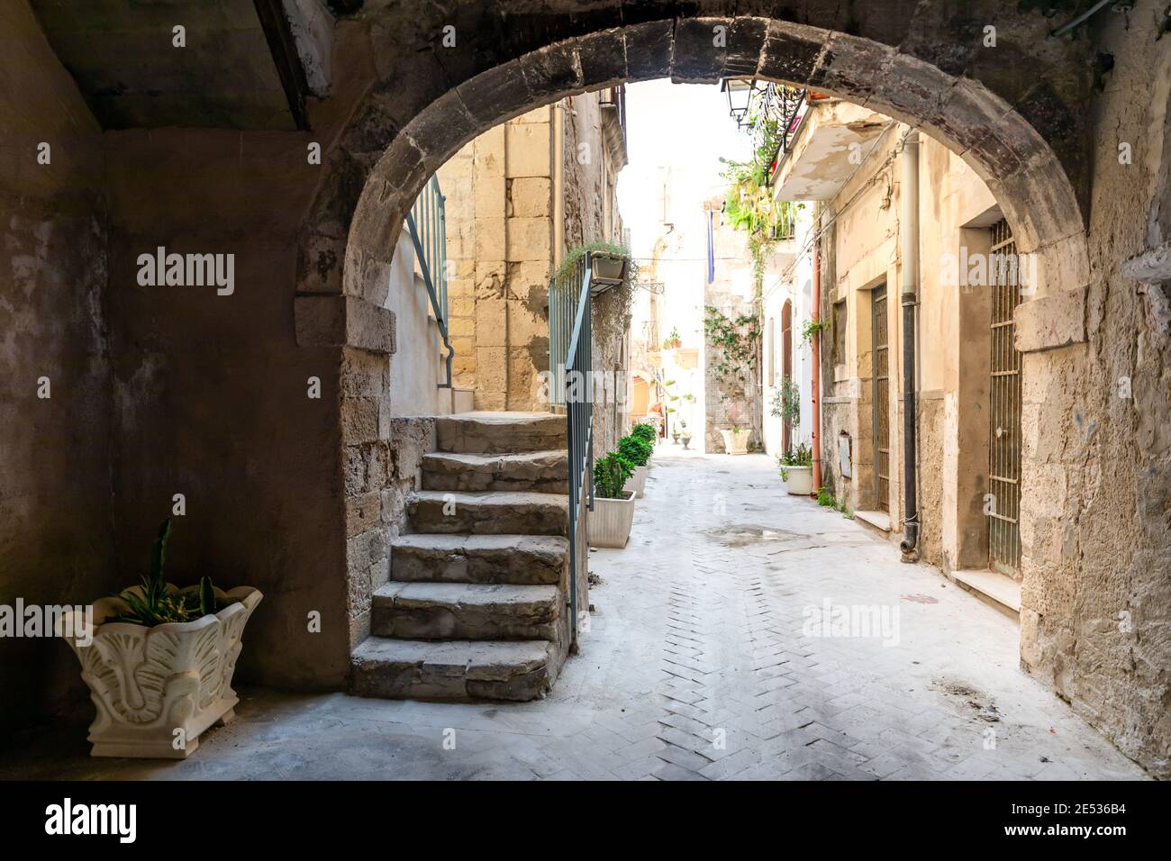 An ancient vaulted backalley in southern Italy, leading to a row of private houses Stock Photo
