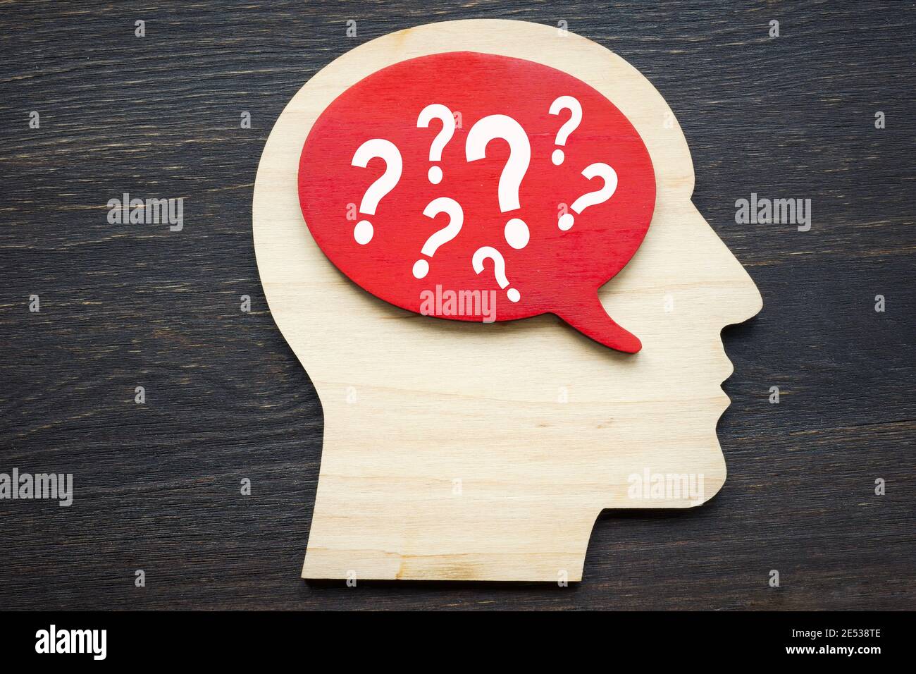 Assumptions concept. Human head shape with question marks. Stock Photo