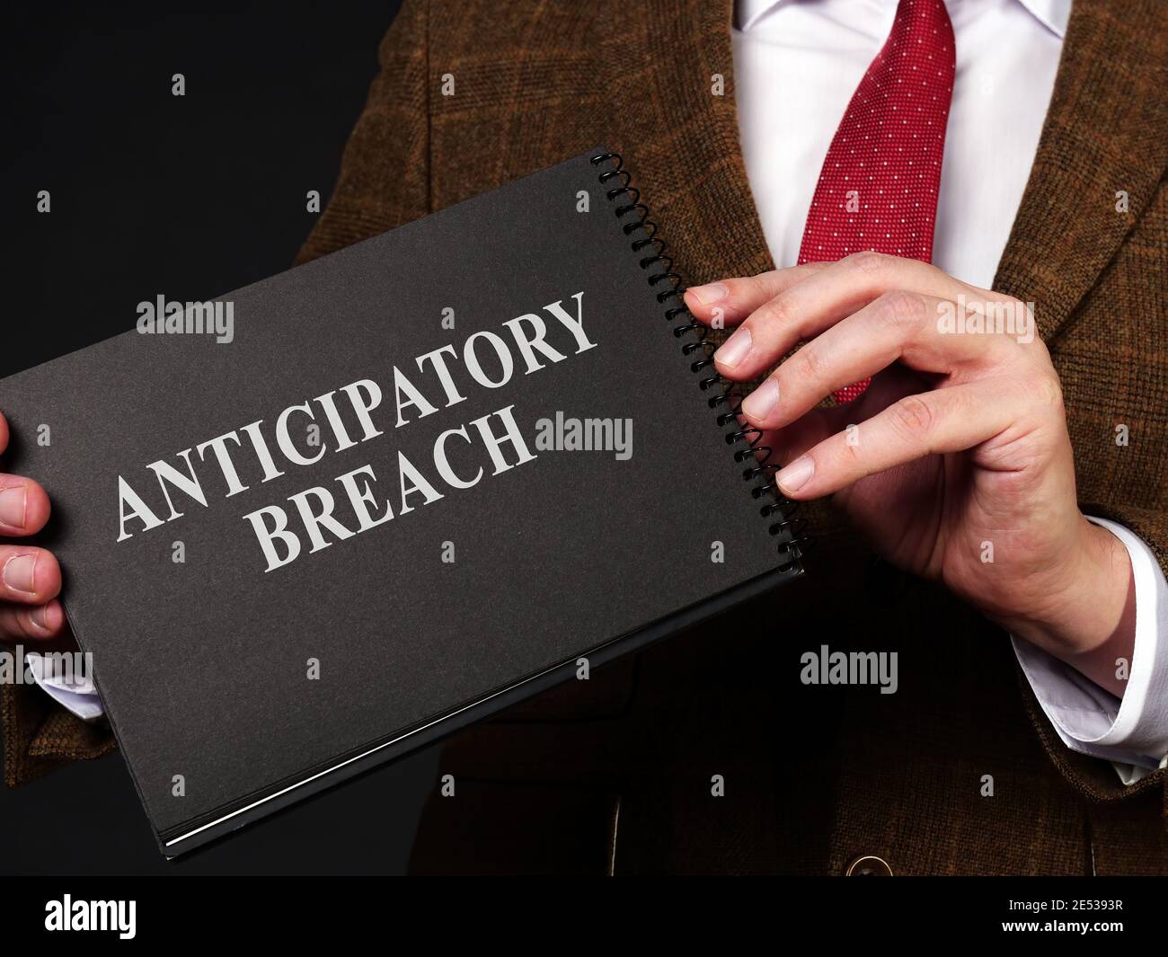 Man holds papers about anticipatory breach of contract. Stock Photo