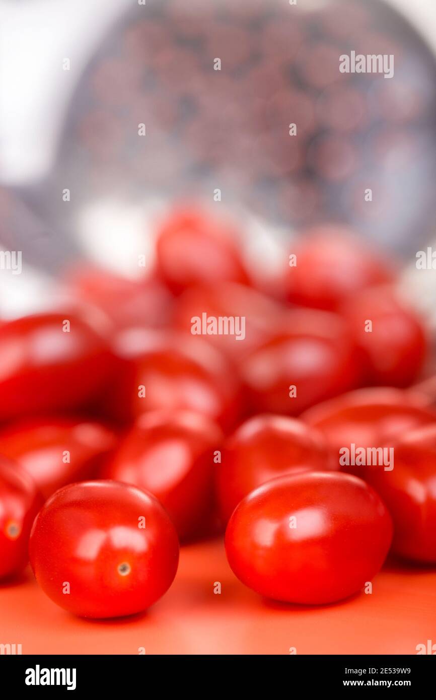 Small tomatoes on the natural metal background. Stock Photo