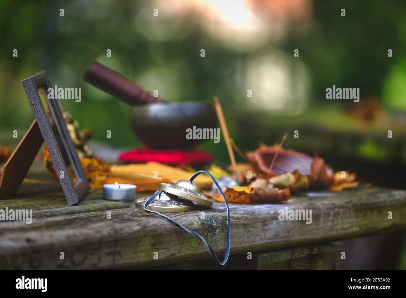 Yoga meditation objects on wooden table outdoors Stock Photo