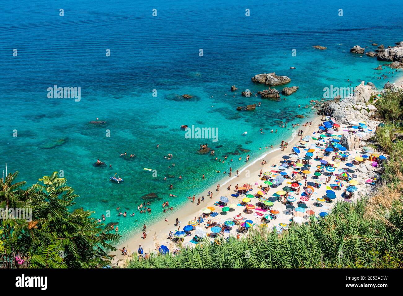 Michelino beach in Parghelia near Tropea during summertime, Calabria, Italy. Sandy beach full of vacationers and colorful umbrellas Stock Photo